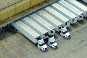 line up of corporate cdl trained truckers parked at fulfillment center