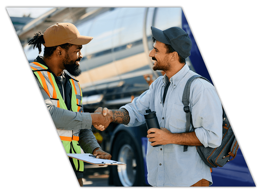 Two truck drivers shaking hands after company CDL training in Arkansas